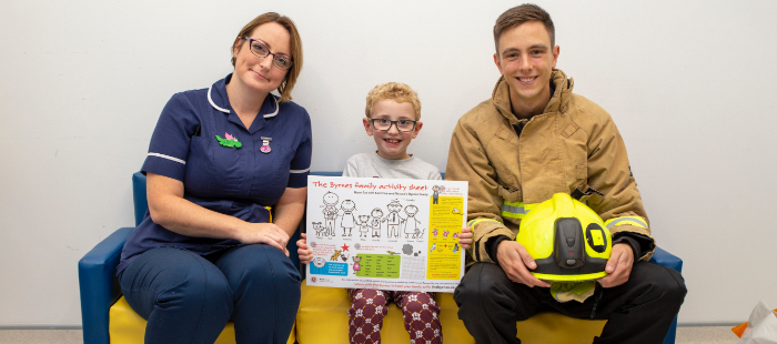 Child holding the byrnes family activity sheet