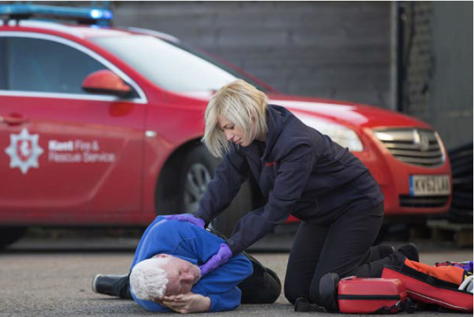 Kent Fire & Rescue fire woman with member of the public teach resuscitation