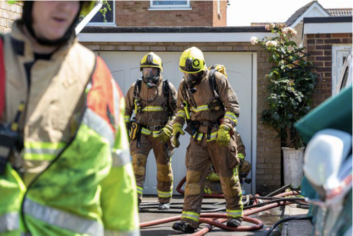 Kent Fire & Rescue fire officers at a residence