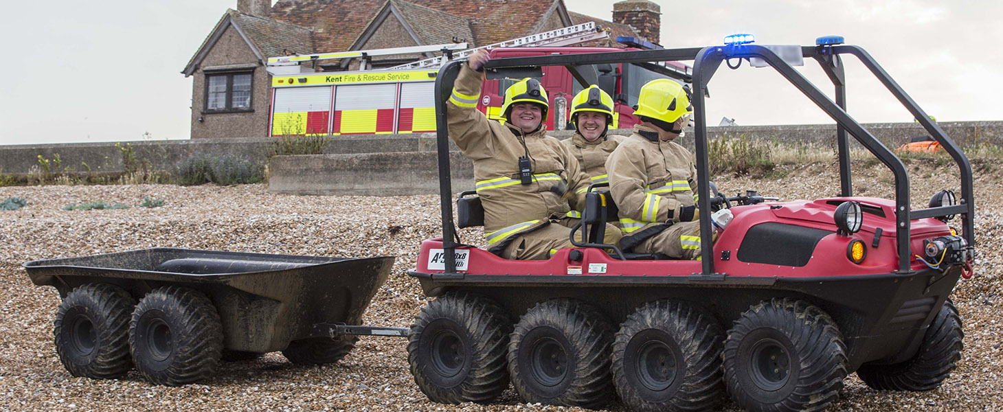 Cross terrain vehicle one beach with three firefighters on-board